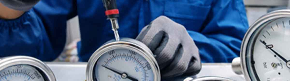 Technician servicing industrial pressure instrumentation